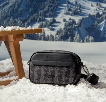 Bolsa cruzada Lacoste negra y con estampado, de acabado suave, con cierre de cremallera, correa ajustable y detalle del logo.