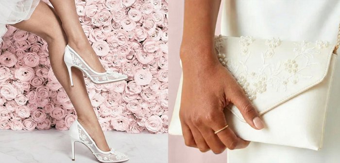 Legs wearing white lace high heels with floral embroidery, posed against a wall covered in pale pink roses.