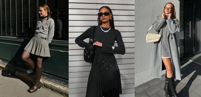 Dve ženy oblečené v sivom vonkajšom odeve a čižmách po kolená stoja vonku; jedna v plisovanej sukni s vzorovanými pančuchami, druhá v pruhovaných šatách s béžovou kabelkou.