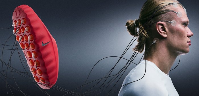 Red silicone massager with rounded nodules and a smooth base, floating above a person’s head against a dark background.