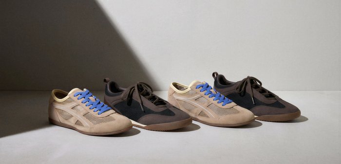 Two pairs of casual sneakers, one in beige with blue laces and one in dark brown with matching laces, arranged side by side on a gray surface.