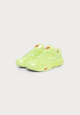 Pair of bright lime green athletic shoes with red logo accents on white background.