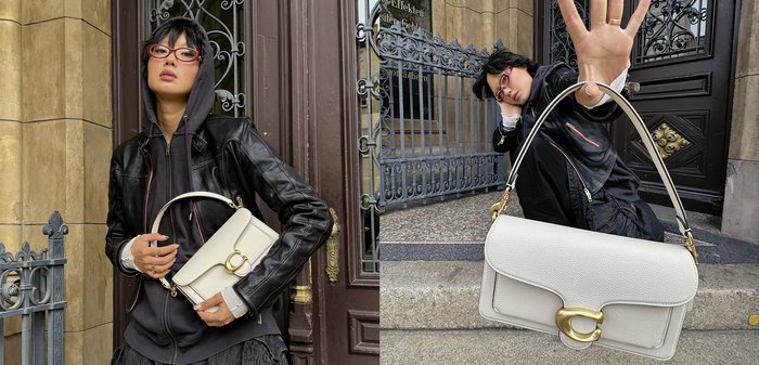 Weisse Lederhandtasche mit glatter Textur, gewölbtem oberen Teil und goldenen Beschlägen. Verfügt über eine strukturierte Form, einen kurzen Griff und einen Verschluss mit Klappe.