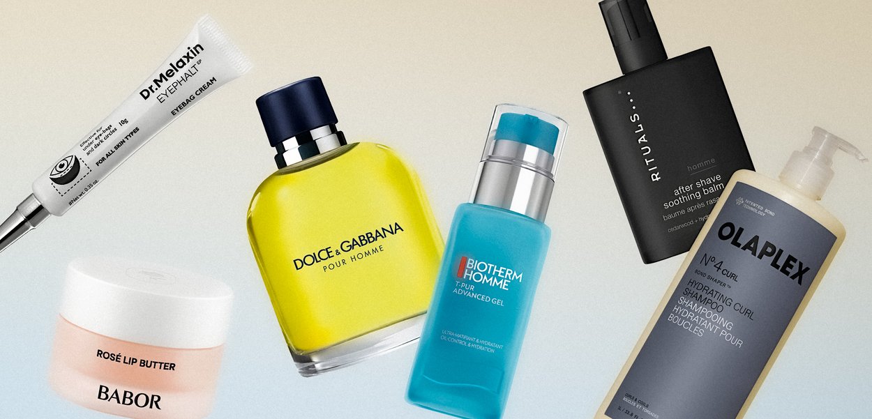 Produits de soin de la peau et de toilettage pour hommes disposés sur une surface claire, incluant crème pour les yeux, baume à lèvres, eau de Cologne, gel, baume après-rasage et shampooing hydratant.
