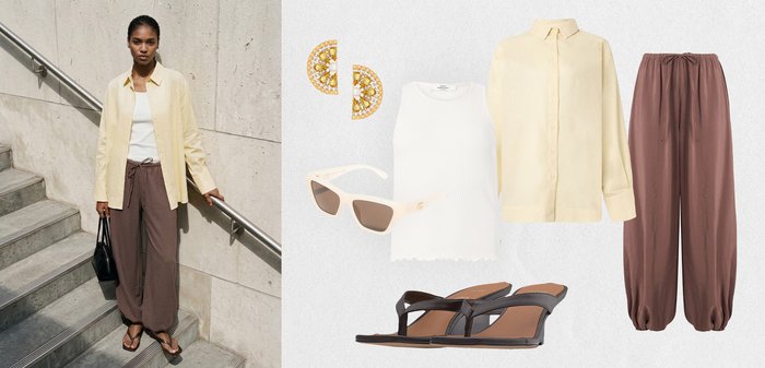 Γυναίκα που φοράει κρεμ πουκάμισο, λευκό φανελάκι, φαρδιά καφέ παντελόνια, μαύρα σανδάλια, κρατώντας μαύρη τσάντα· εμφανίζονται ταιριαστά σκουλαρίκια, γυαλιά ηλίου και στοιχεία της στολής.