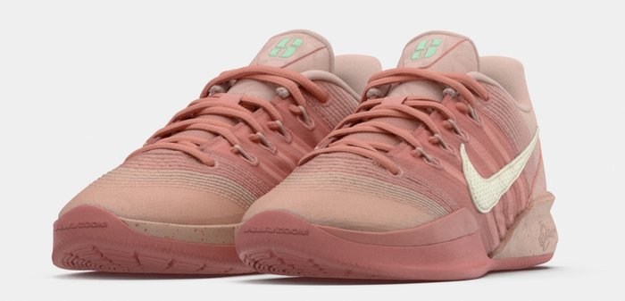 Chaussures de sport roses en tissu texturé, logo Nike crème, lacets inclinés et semelle en caoutchouc avec des accents tachetés subtils.