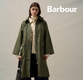 Olive green waterproof coat with a hood, featuring large front pockets and gold hardware details. Paired with a cream sweater underneath.