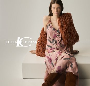Floral pink dress with soft fabric, V-neck, and ruching detail, paired with a textured rust-colored faux fur jacket and brown knee-high boots.