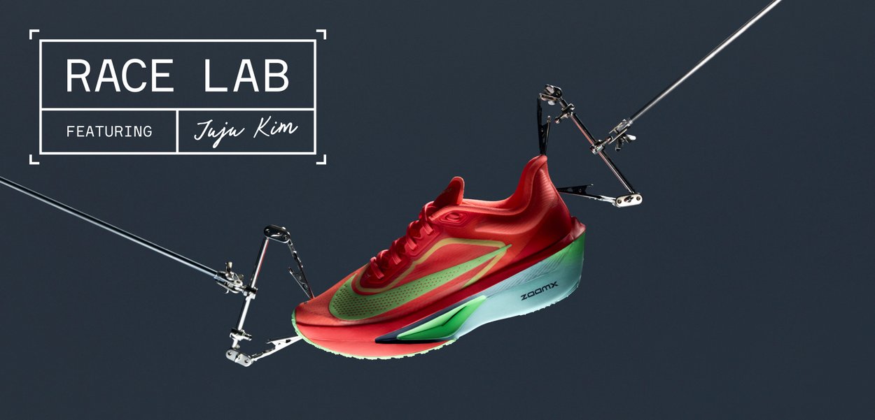 Red running shoe with green-blue accents, featuring a streamlined design, textured upper, and "ZOOMX" branding on the sole.
