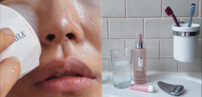 Appareil blanc de nettoyage facial dans la main près de la peau humide, verre d'eau glacée, spray hydratant rose Clinique, tube de crème, et accessoire argenté.
