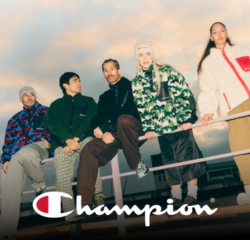 Five individuals wear cozy, colorful outerwear in various textures, including fleece and patterned designs, standing on a railing.