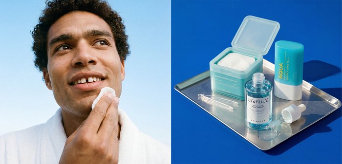 Homme aux cheveux courts et bouclés portant une robe blanche applique des soins de la peau avec un coton; les produits de soin sur un plateau en métal comprennent un tonique, un stick et des lingettes.