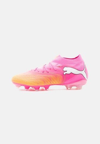 Pink soccer cleat with orange accents, white Puma logo on the side, laces on top, and clear studs on the sole, displayed on a plain background.