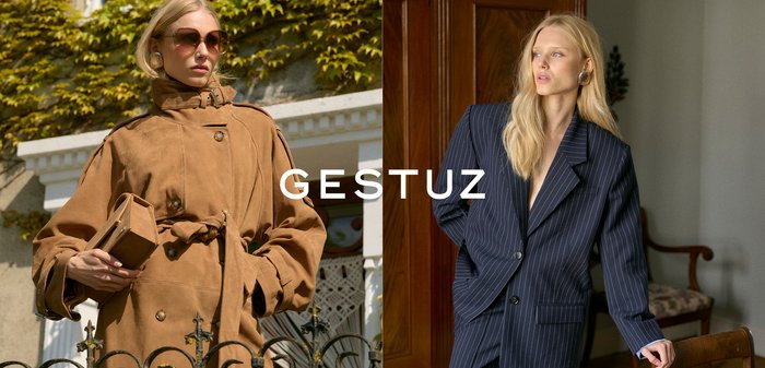 Dva modela prikazuju vanjsku odjeću: smeđi trenč s elastičnim remenom od antilopa i mornarsko plavi prugasti blejzer sa širokim reverima.