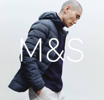 Navy puffer jacket with a hood, featuring ribbed texture and zip closure, worn over a dark polo shirt, against a light background.