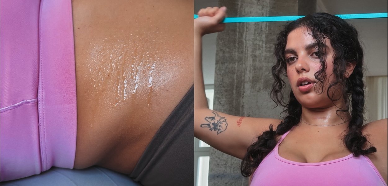 Κοντινό πλάνο λαμπερής επιδερμίδας με σταγόνες ιδρώτα, συνδυασμένο με φιγούρα σε ροζ αθλητικό τοπ που κρατά μια μπλε κορδέλα αντίστασης.