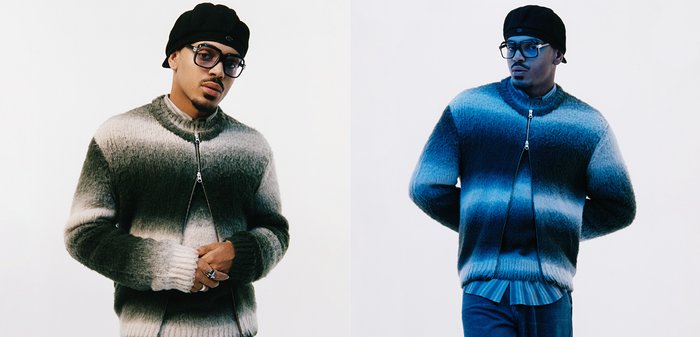 Gestrickter Pullover mit Reißverschluss vorne, präsentiert ein Ombre-Muster, das von Grau zu Blau übergeht, mit gerippten Bündchen und hohem Kragen.