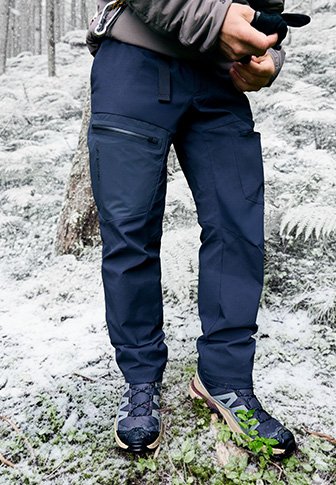 Ναυτικές αδιάβροχες cargo παντελόνες με πολλές τσέπες, ελαστική μέση και ενισχυμένες ραφές, συνδυασμένες με υφασμάτινα υποδήματα κατάλληλα για υπαίθριες δραστηριότητες.