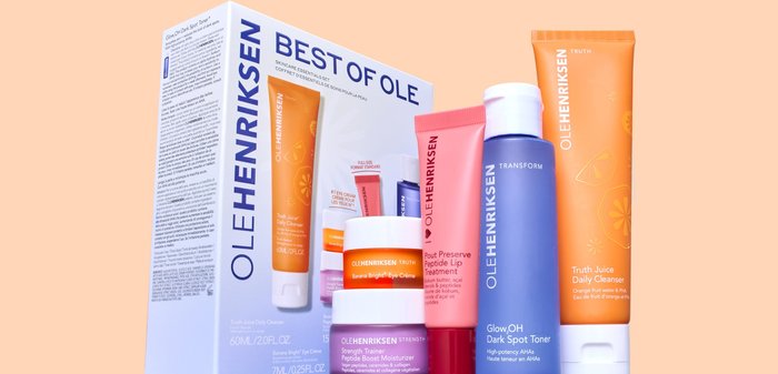 Skincare set includes five products with colorful tubes: orange, pink, purple, and white. Packaging features bold text and fruit illustrations.
