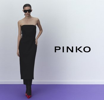 Vestido negro sin mangas de largo hasta el suelo con una silueta ajustada, combinado con tacones de aguja rojos brillantes y gafas de sol negras de gran tamaño.