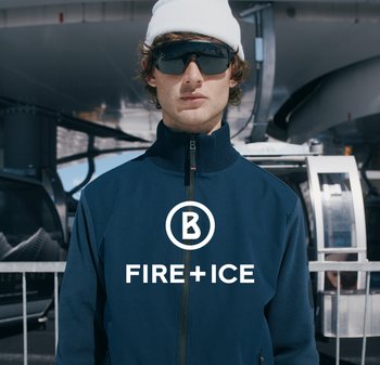 Granatowa kurtka rozpinana z wysokim kołnierzem, wykonana z miękkiego materiału. Posiada logo na piersi oraz tło w postaci wyciągu narciarskiego.