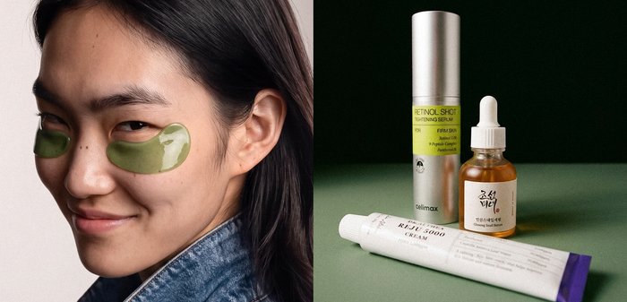 Femme aux cheveux foncés portant des patchs verts sous les yeux à côté de trois produits de soin de la peau, dont un sérum, un flacon compte-gouttes et un tube de crème.