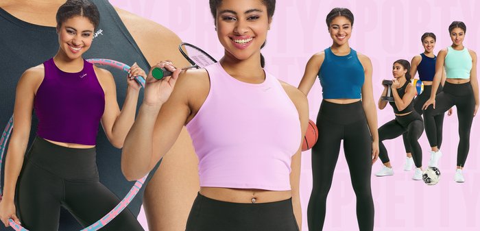 Sæt med atletisk tøj bestående af en lyserød cropped top, sorte high-waisted leggings og en lilla top, med forskelligt sportsudstyr i baggrunden.