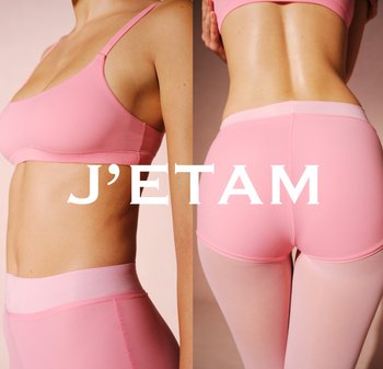 Reggiseno seamless rosa e leggings a vita alta, caratterizzati da una texture liscia, spalline sottili e una cintura morbida, esposti su uno sfondo neutro.