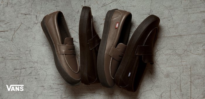 Fire Vans slip-on sko i brunt og svart med tykke såler, arrangert på en sprukket betongflate, Vans-logo synlig.