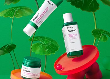 Three skincare products from Dr. Jart+, featuring bright green packaging, are displayed on colorful circular platforms with leafy backgrounds.