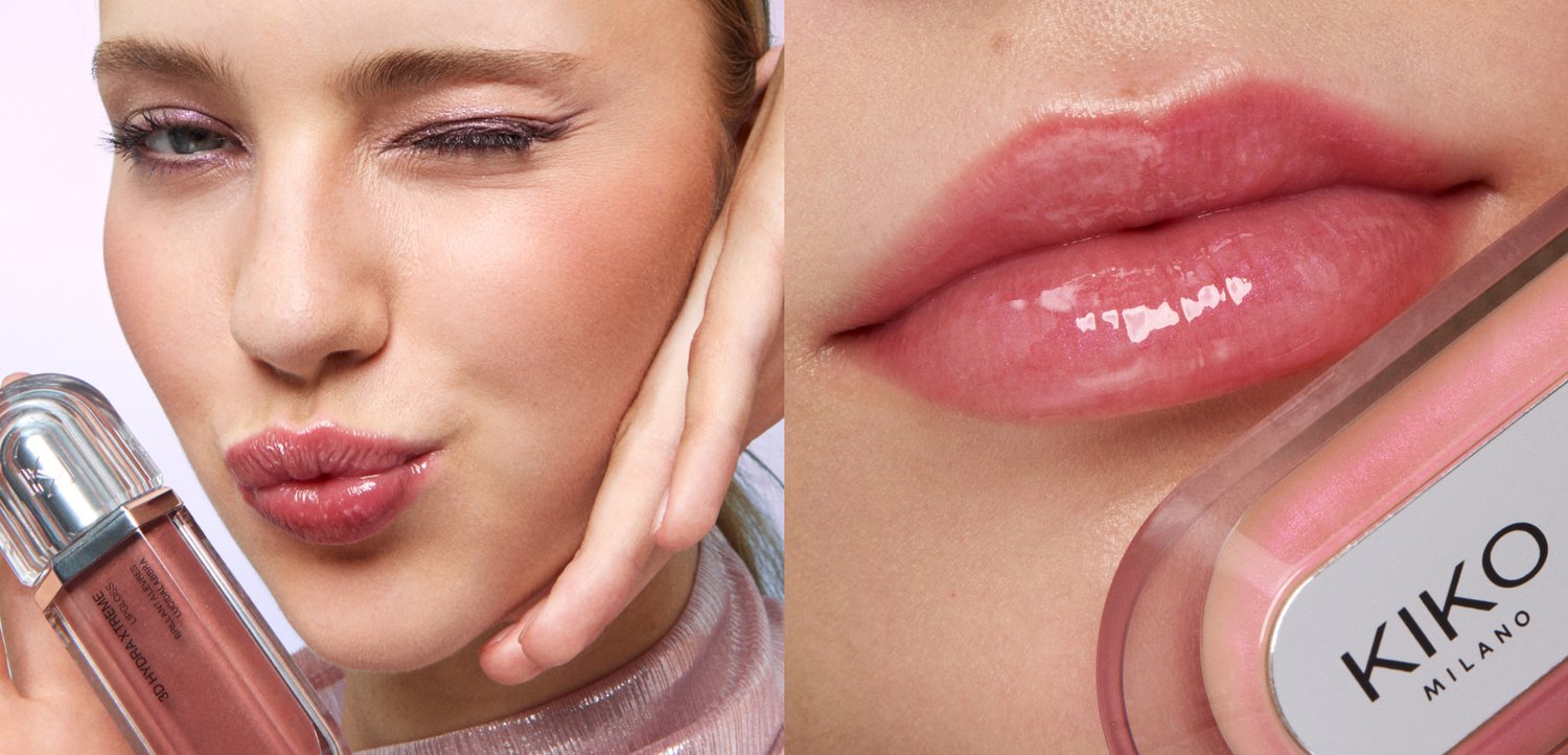 Young woman with glossy pink lips winking and holding a tube of Kiko Milano lip gloss close to her face.