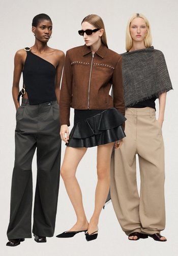 Τρεις γυναίκες στέκονται· η μία με μαύρο τοπ με ένα ώμο και σκούρα φαρδιά παντελόνια, η μία με καφέ τζάκετ με τρουκς, μαύρη βολάν φούστα και γυαλιά ηλίου, και η τρίτη με γκρι ριχτό και μπεζ φαρδιά παντελόνια.