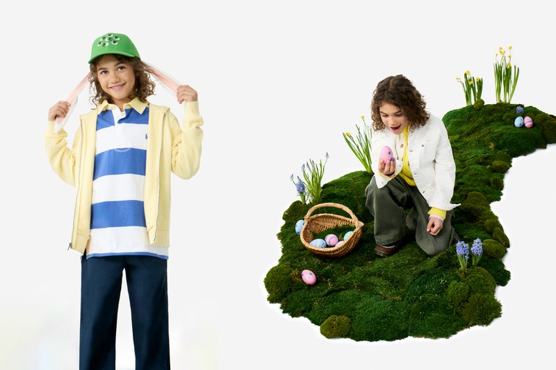 Girl holding pigtails wearing green cap and yellow jacket; child kneeling on moss with basket, holding decorated Easter egg.