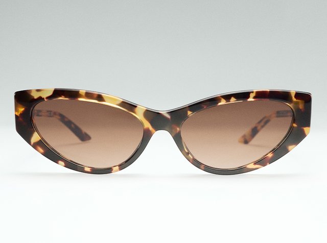 Cat-eye sunglasses in a tortoiseshell pattern with gradient lenses, centered against a light gray background.