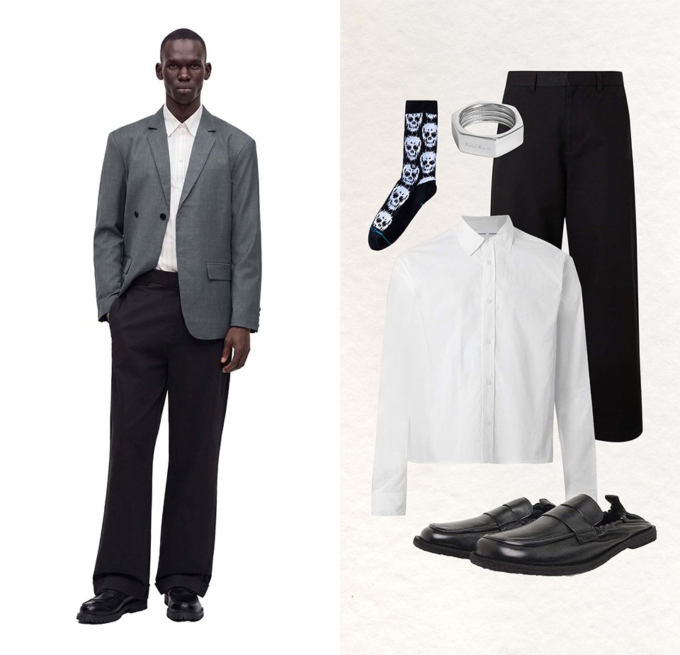 Man med grå blazer, vit skjorta, svarta byxor och svarta skor; bredvid svarta byxor, vit skjorta, strumpor med dödskallemönster, silverarmband och svarta loafers.
