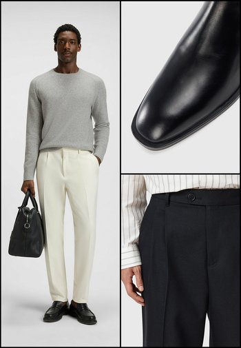 Black leather shoes with a square toe, gray knit sweater, and cream trousers. Detail of black pleated trousers with a button and striped shirt.