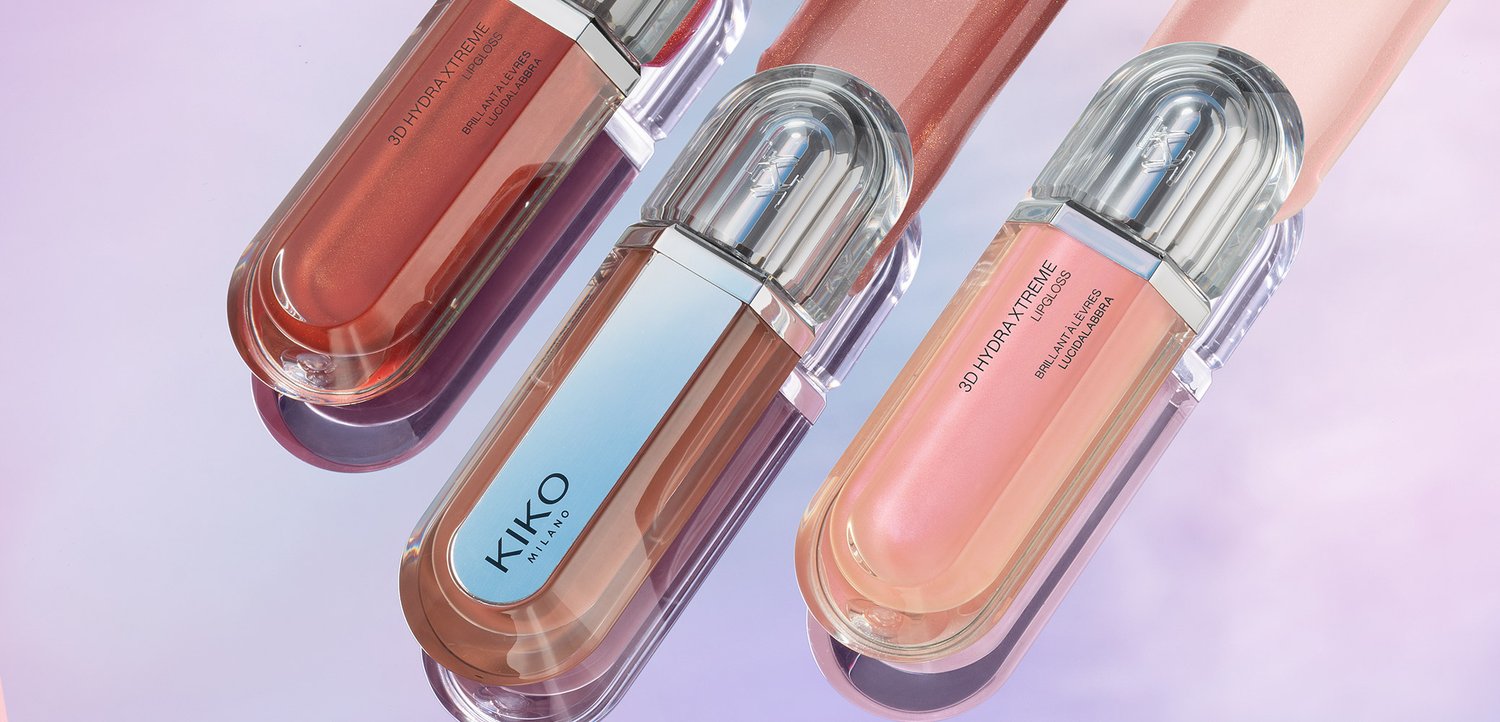 Three KIKO Milano 3D Hydra Xtreme lip gloss tubes in pink, nude, and brown shades on a reflective surface.
