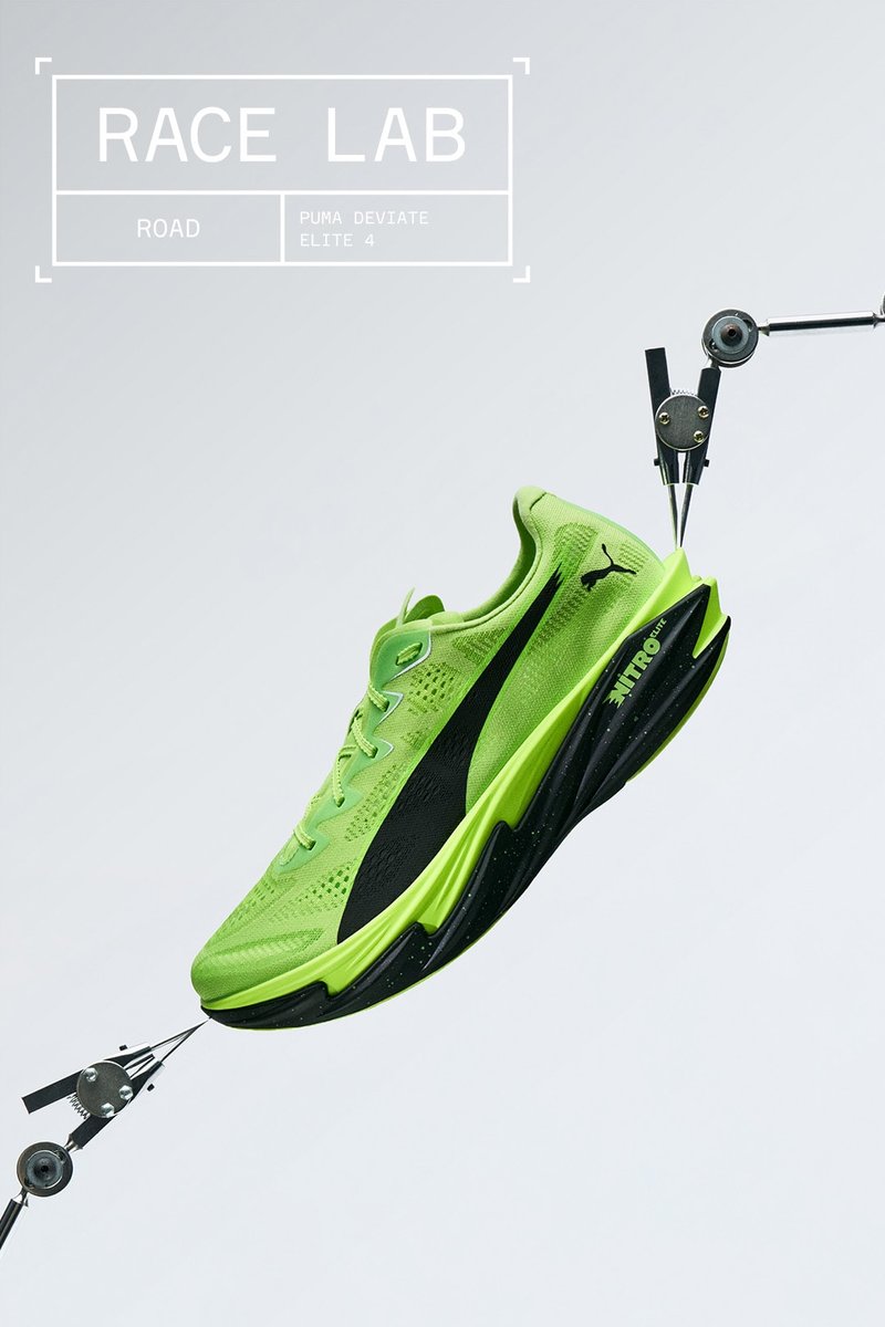 Green Puma Deviate Elite 4 running shoe suspended between two mechanical clamps on a light gray background with "Race Lab" text.