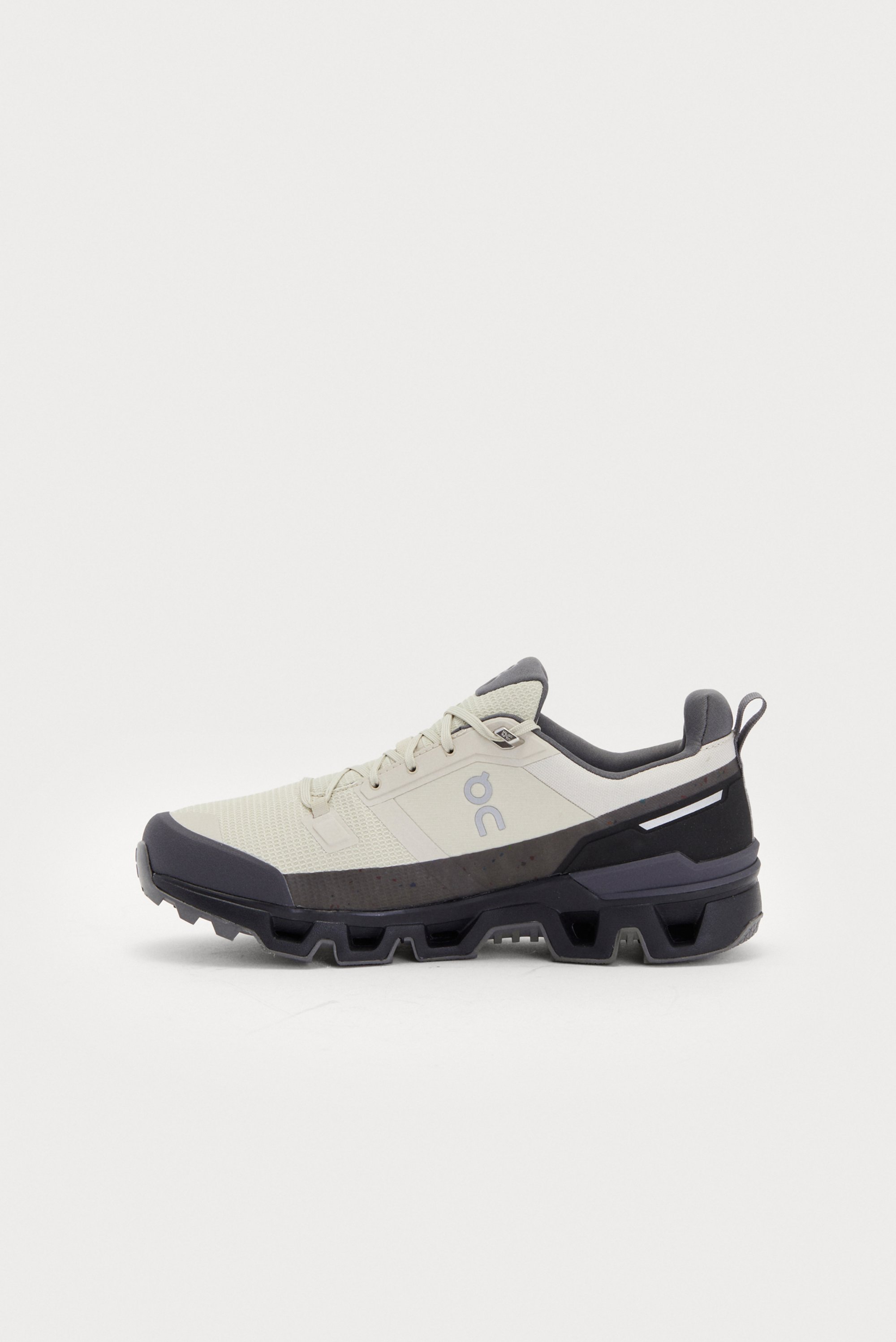 Light-colored athletic shoe with dark accents, featuring a textured upper and a rugged sole designed for outdoor activities.