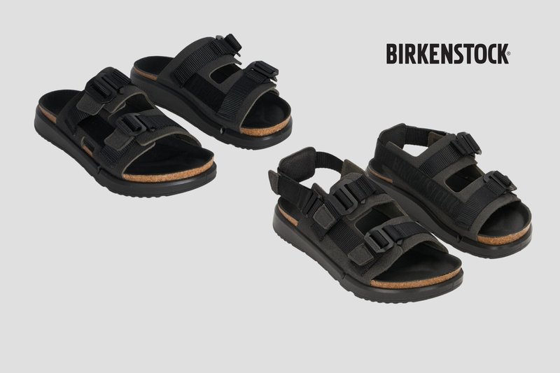 Two pairs of black Birkenstock sandals with adjustable straps and cork footbeds on a gray background.