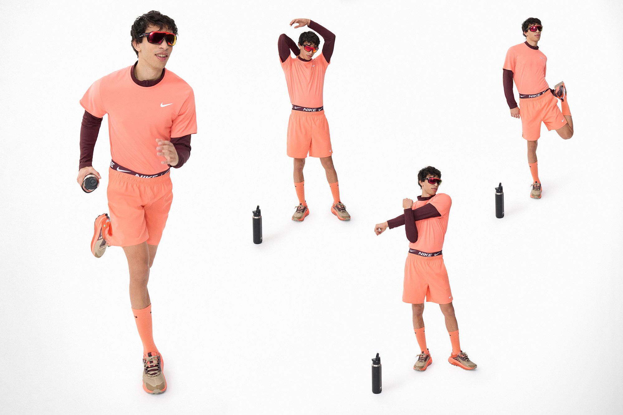 Una persona con vestimenta deportiva de color naranja brillante corre, se estira y se prepara con una botella de agua cerca, mostrando ropa deportiva activa.