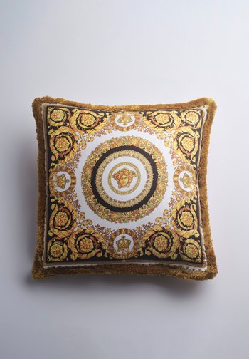 Τετράγωνο διακοσμητικό μαξιλάρι με χρυσό και μαύρο μοτίβο μπαρόκ, κεντρική κεφαλή Μέδουσας, ανθικά σχέδια και χρυσές φουντωτές άκρες σε λευκό φόντο.