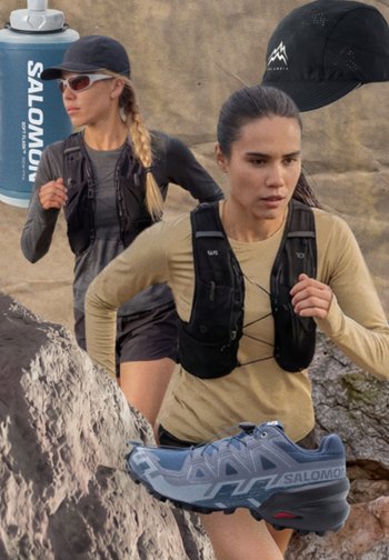 Two women trail running over rocky terrain wearing hydration vests; hiking shoe, water bottle, and black cap with mountain logo nearby.