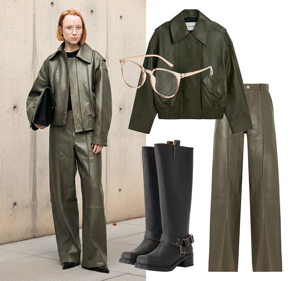 Femme portant une veste en cuir vert olive et un pantalon à jambes larges, avec des bottes noires et des lunettes beige clair, tenant une pochette noire.