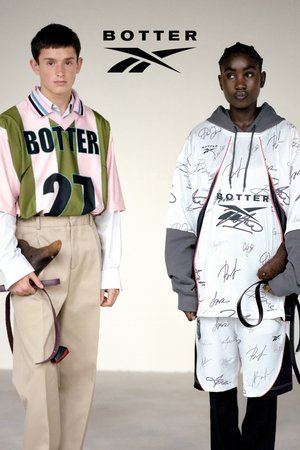 Two models stand side by side, one in a green and pink jersey with the number 27, the other in a white oversized hoodie with signatures.