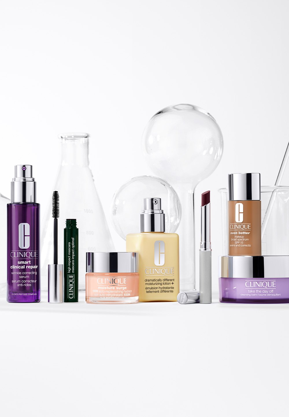 Clinique skincare products arranged on a white surface. Bottles and jars feature varying shapes; colors include purple, green, yellow, and pink.