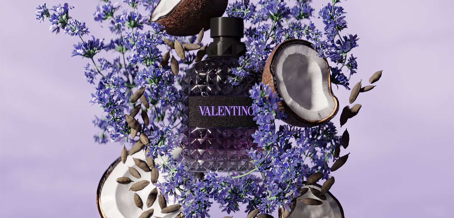 Perfume bottle labeled Valentino surrounded by purple flowers, coconut halves, and scattered seeds on a light purple background.