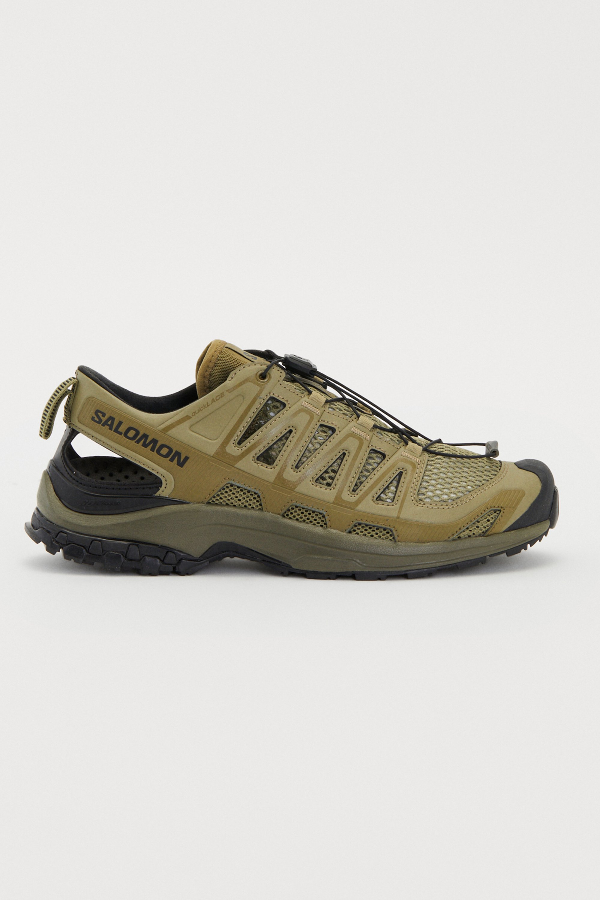 Lightweight, breathable hiking shoes in olive green with a mesh upper, rubber outsole, and elastic lacing system for secure fit.