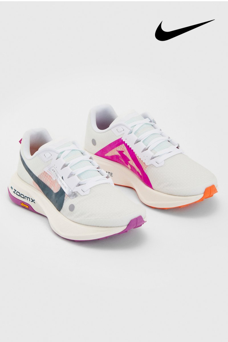 White Nike sneakers with mesh accents and colorful details in purple, pink, and orange. Features prominent branding and lightweight design.