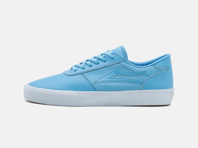 Light blue low-top sneaker with lace-up design and white rubber sole, shown from outer side on plain background.